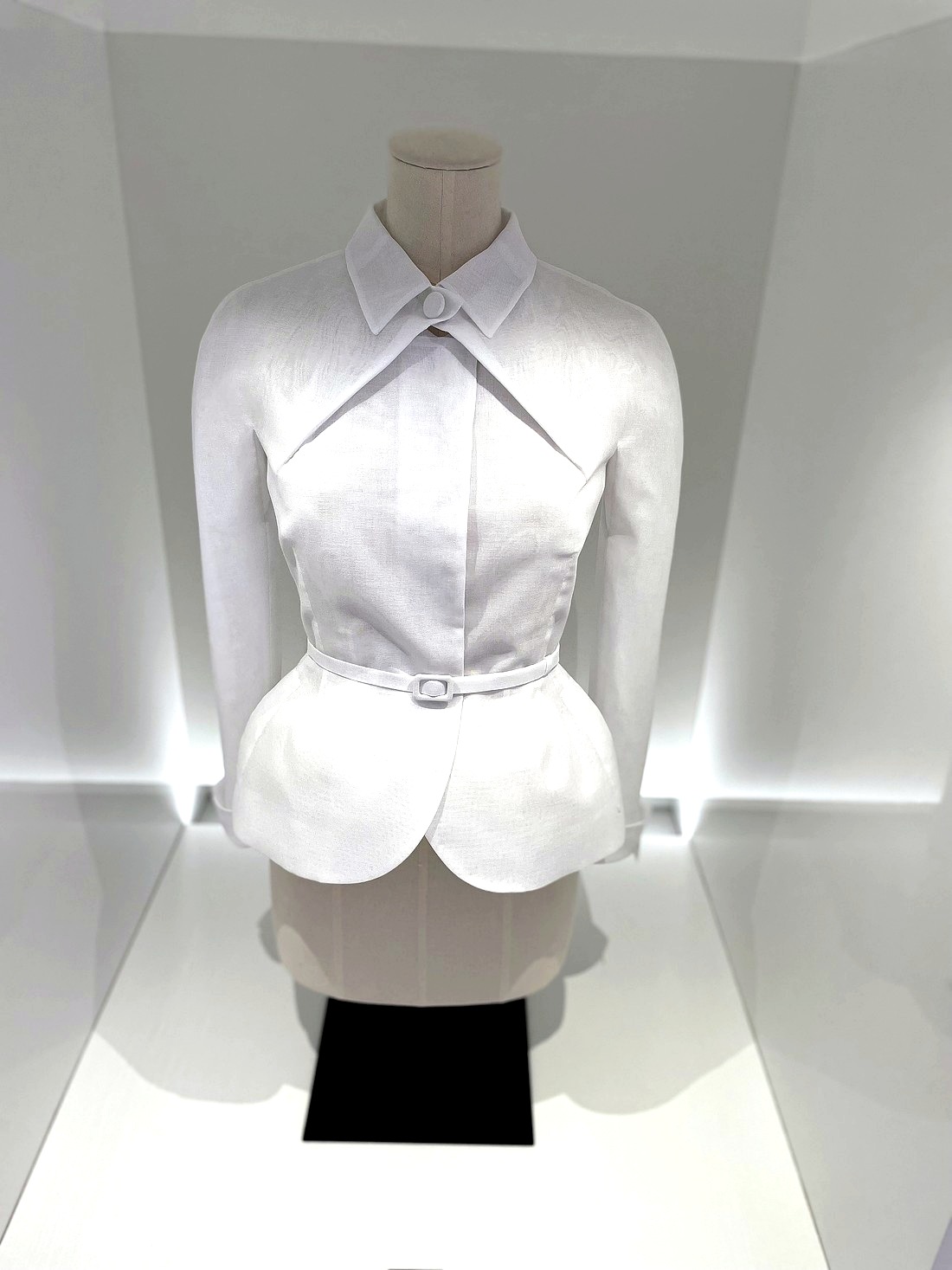 Detailaufnahme einer hellen Bluse im Kleiderschrank